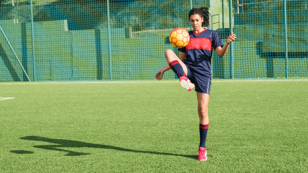 female player playing soccer