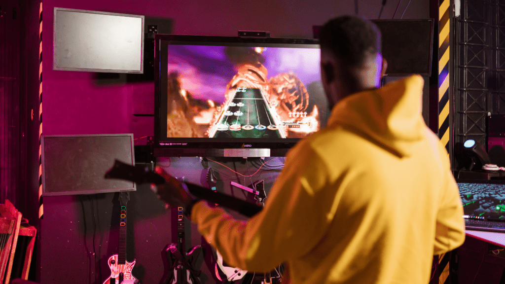 yellow hoodie playing guitar hero