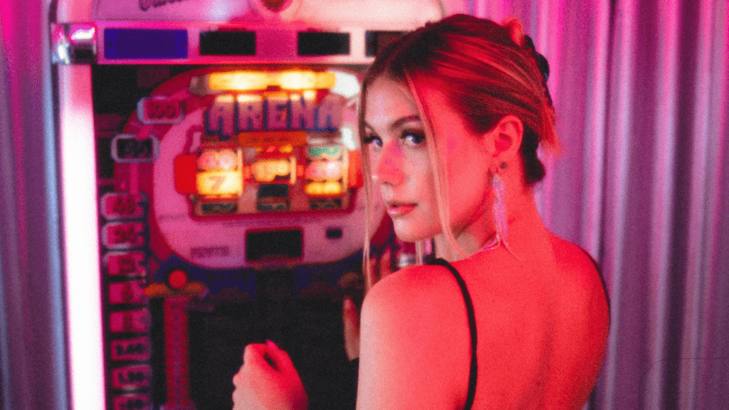 woman standing next to a slot machine