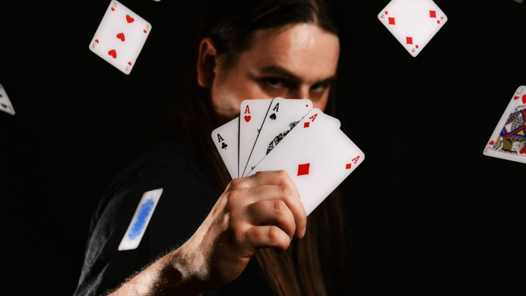 man holding 4 ace cards