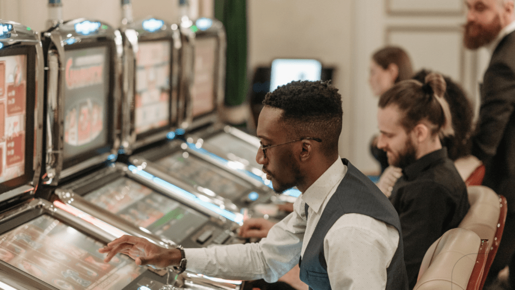 man seriously playing slot machine