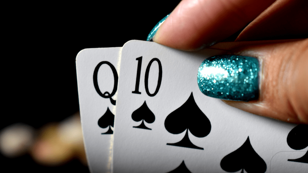 woman holding poker cards